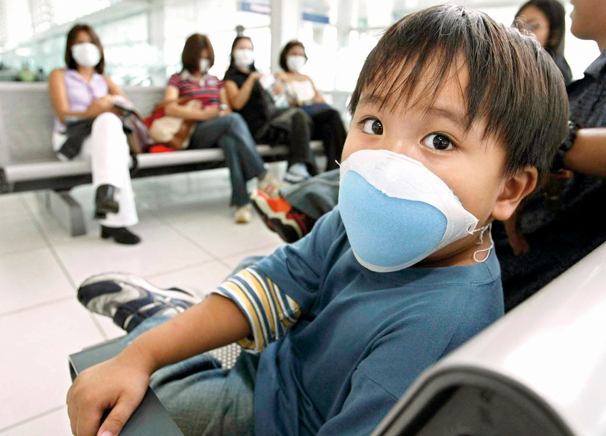 Fear of SARS: Passengers at Manila Airport wear masks.