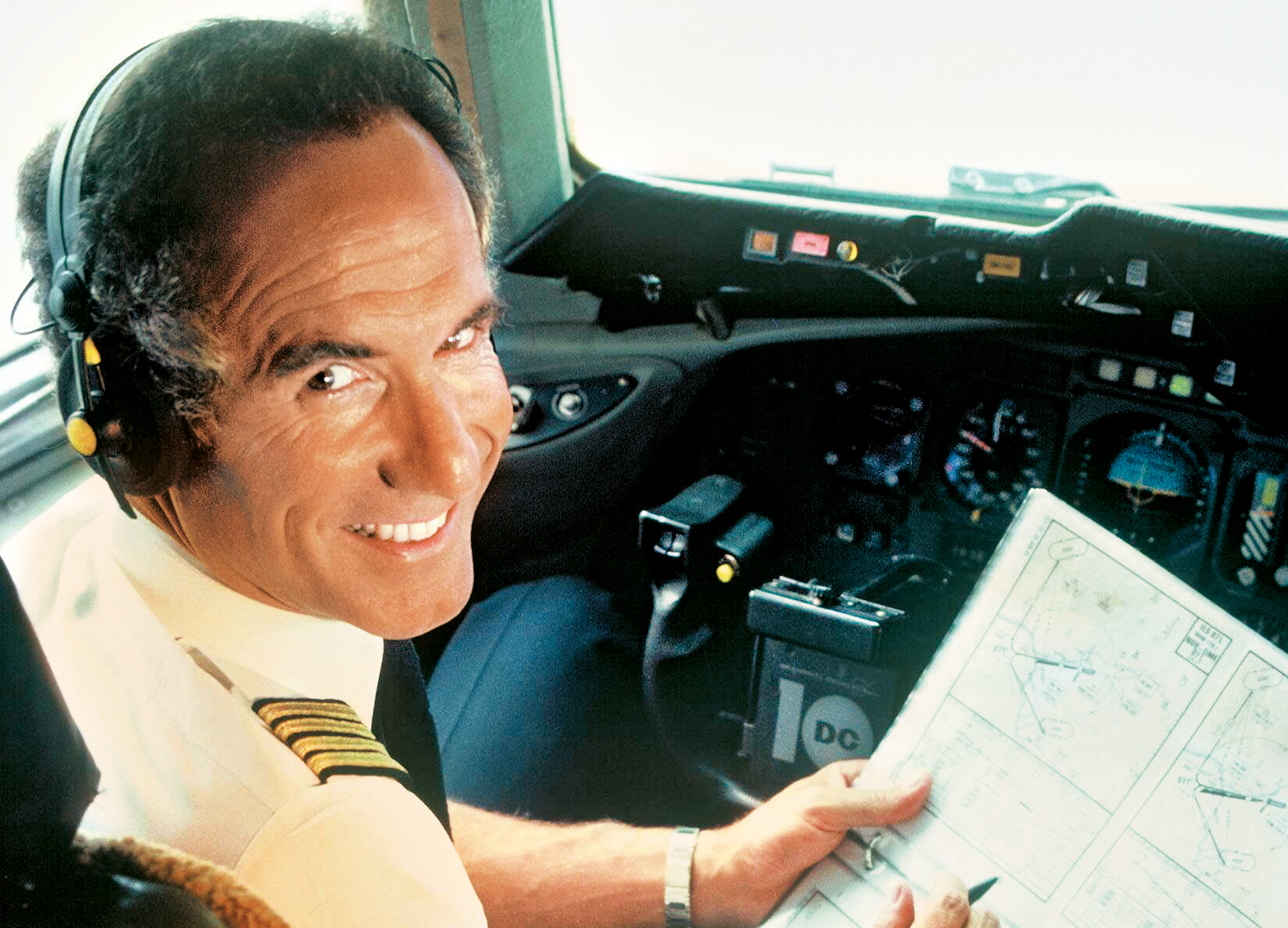 A Lufthansa flight captain studying route maps.