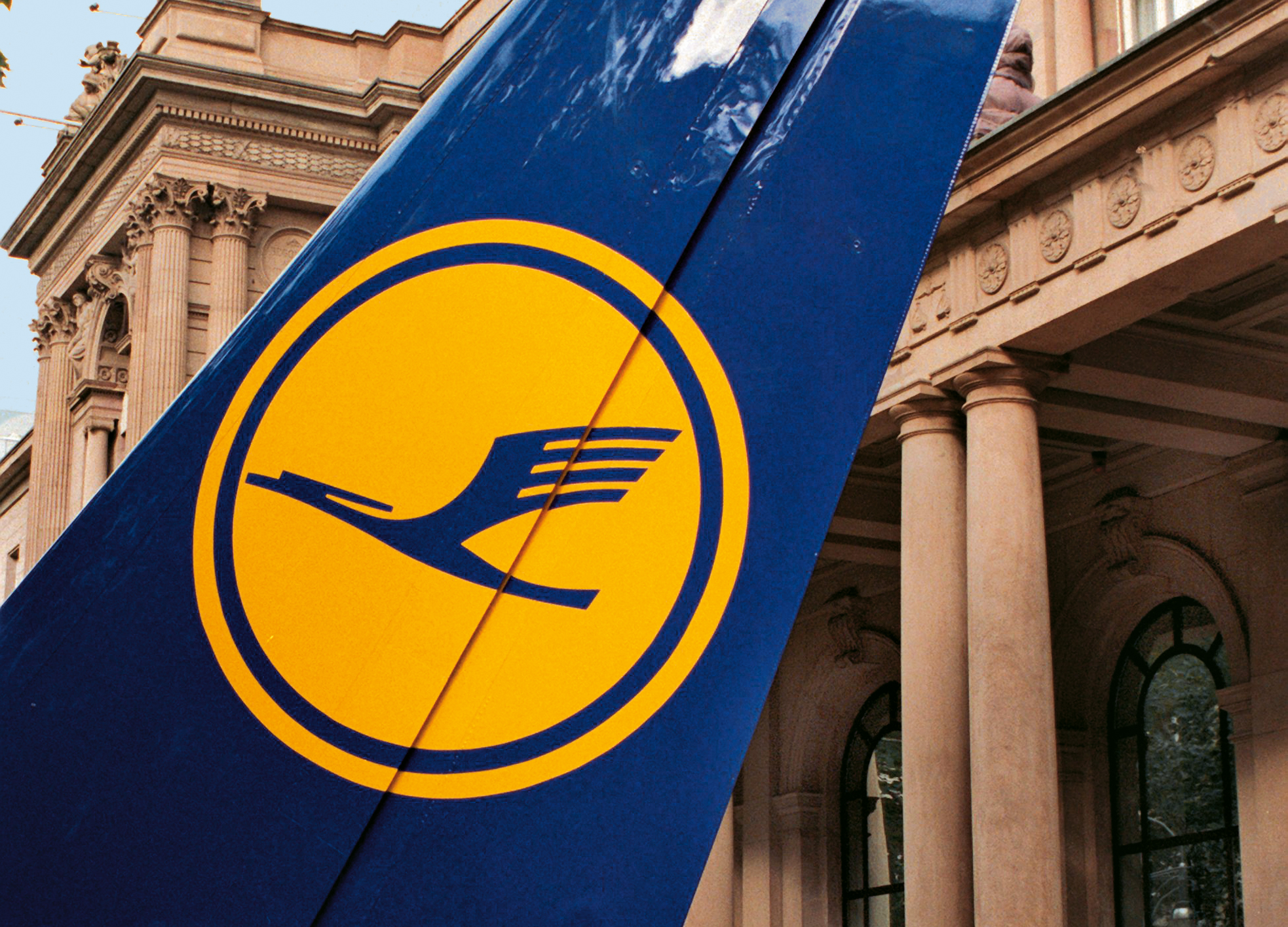 The horizontal stabilizer of an Airbus carries the Lufthansa colors to the doorstep of the Frankfurt Stock Exchange.